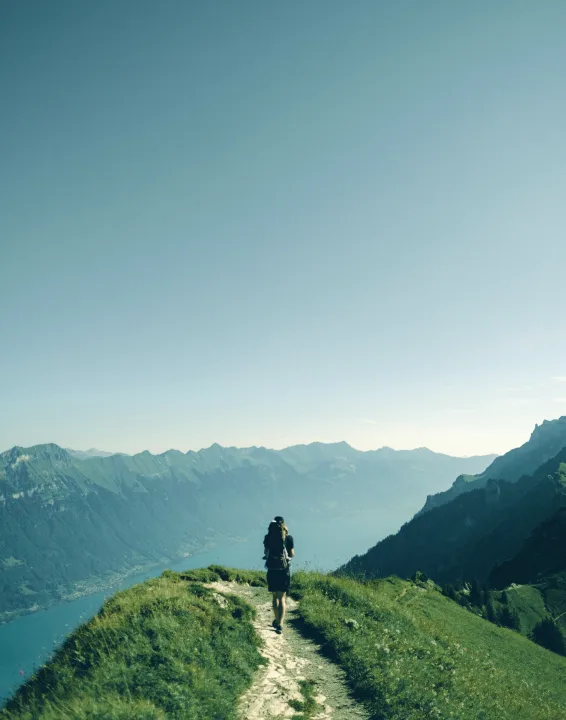 A traveller on a mountain path overlooking a valley